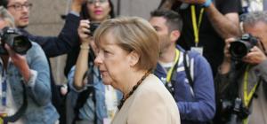 There goes Merkel, dour as usual. Why isn't she more interested in giving the Greeks more money?